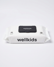 A pack of Wellkids baby wipes in a white resealable package with a black flip-top lid and black printed branding, photographed on a clean white background.